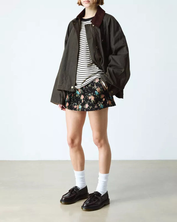 Dr. Martens Adrian Polished Loafer Cherry Red, gedragen door een model in een outfit met jack en rok.