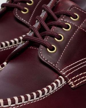 Dr. Martens Lowell Cherry Red, close-up van de veterogen.