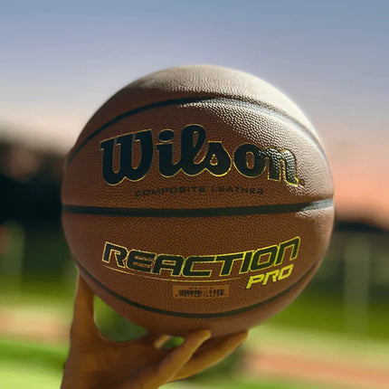 Wilson Reaction Pro Basketbal Indoor _ Outdoor Maat 5,6 & 7 by Burned Sports met Blauw basketbalveld lichte achtergrond