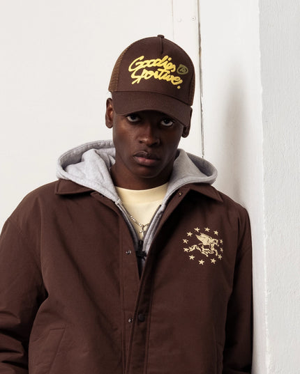 Goodies Sportive Memory Jacket bruin, gedragen door een model over een grijze hoodie, close-up.