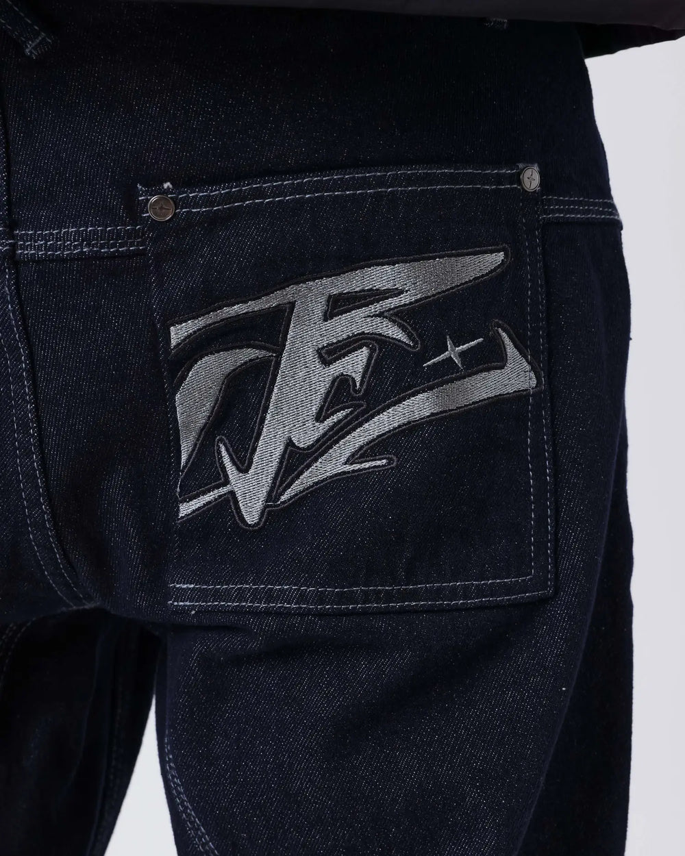 Project X Paris Tag Stiksel Jeans, gedragen, close-up zijaanzicht met windjack.